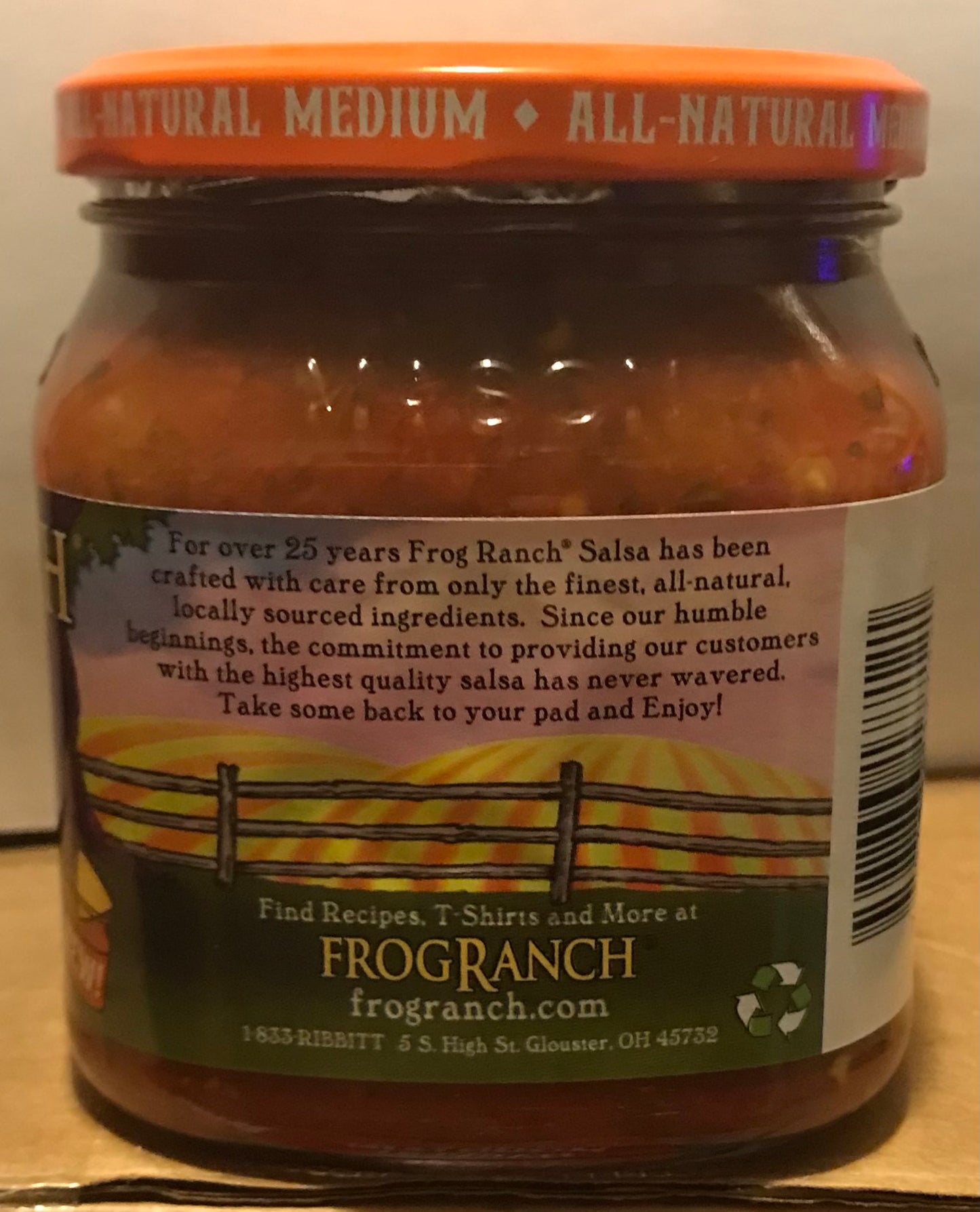 Jar of Frog Ranch salsa with label on a wooden surface