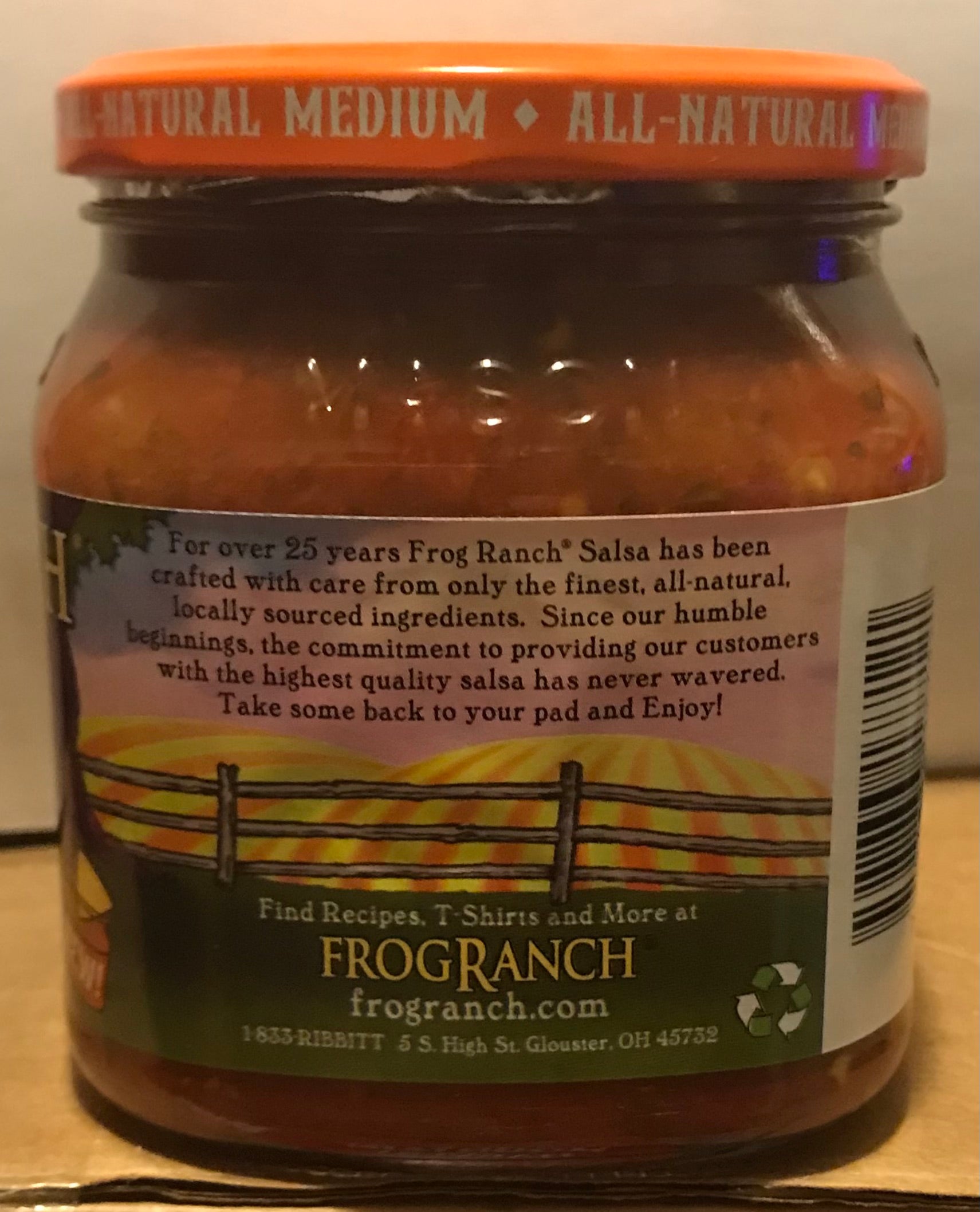 Jar of Frog Ranch salsa with label on a wooden surface