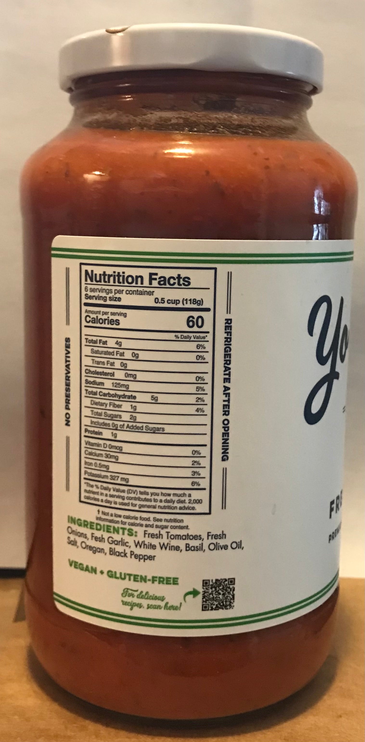 Jar of pasta sauce with a label showing nutrition facts and ingredients.