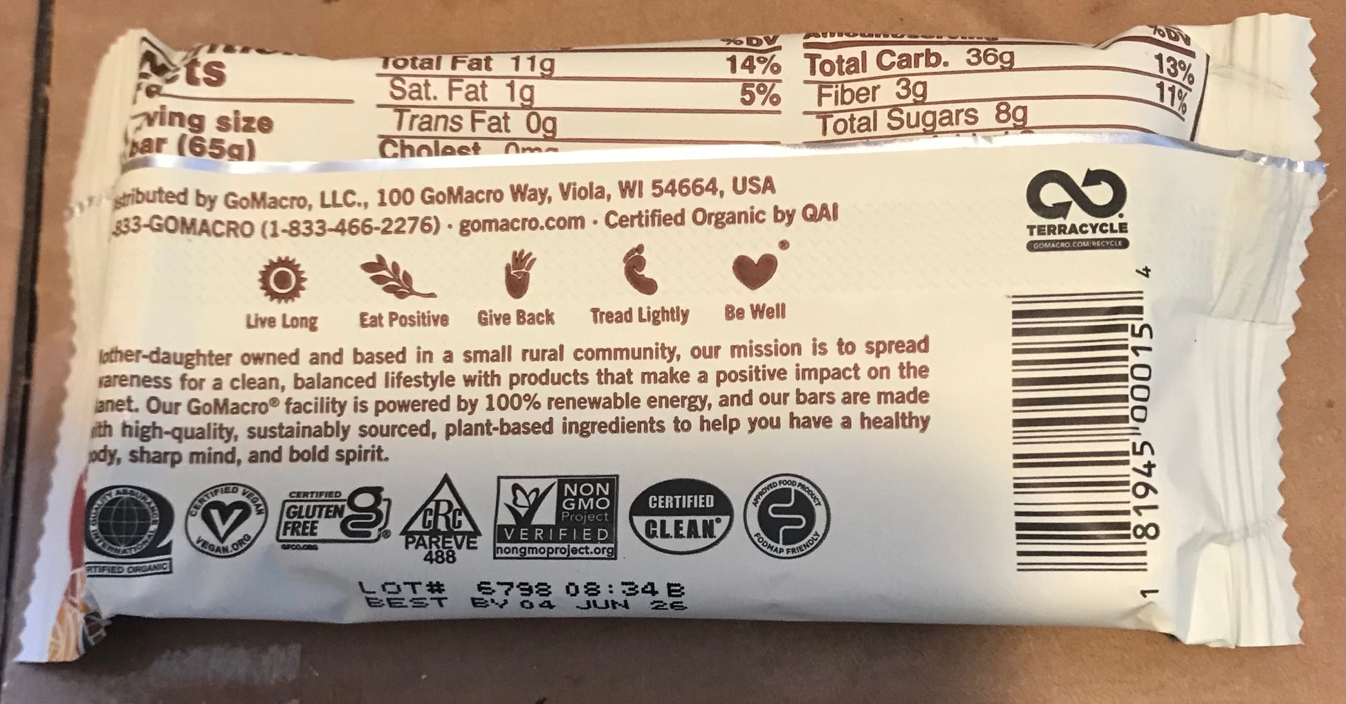 Back of a food package with text, logos, and barcodes on a brown background